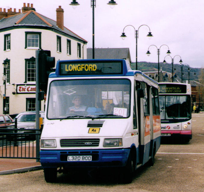 Ford mini bus and Dennis city bus behind it